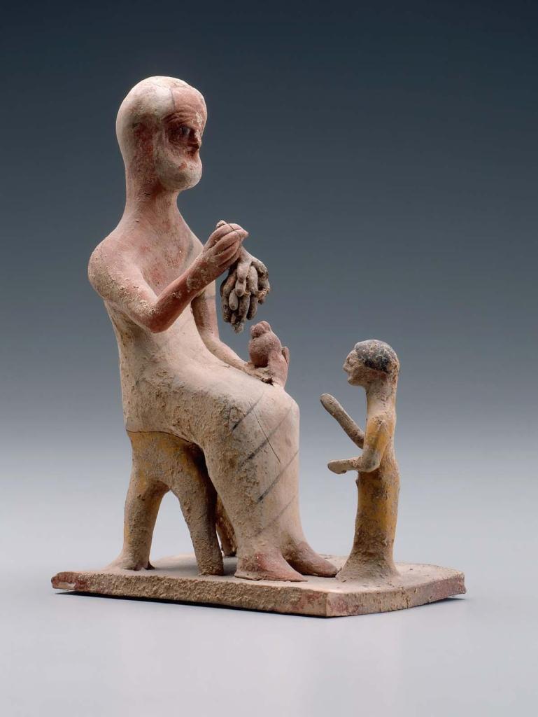 Statuette of an old man offering grapes to a girl.

Grandfathers were important figures in Greek families, as we know from ancient literary sources and inscriptions on grave stelai. This rare late archaic Greek sculpture shows an old, white-haired and partly bald man offering fruit to a small girl. Significant amounts of pigment are preserved on both figures, reminding us that most Greek sculpture was originally painted. Here close looking reveals details of the elegant textiles used to make the elder’s clothing. Such details confirm his status as the grandfather. Terracotta group sculpture in the Museum of Fine Arts, Boston inv. no. 97.350, ca. 500-475 B.C.