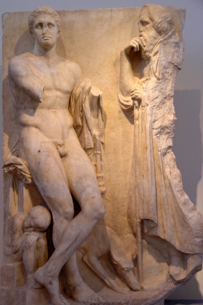 Grave stele showing an Old Man Mourning a Young Man, probably his Son: Greek grave stelai of the 4th and 3rd centuries B.C often show families with several generations including grandparents. The classical style of Greek art at this time minimized the representation of emotion that was seen later in Hellenistic art, but there are still signs of age in these figures of the elderly. This relief combines them: long hair and straggly beard, furrowed brow, hunched posture, a walking stick, and the hand held to the chin in a typical mourning gesture. Relief sculpture in the National Archaeological Museum, Athens, ca. 360-330 B.C.
