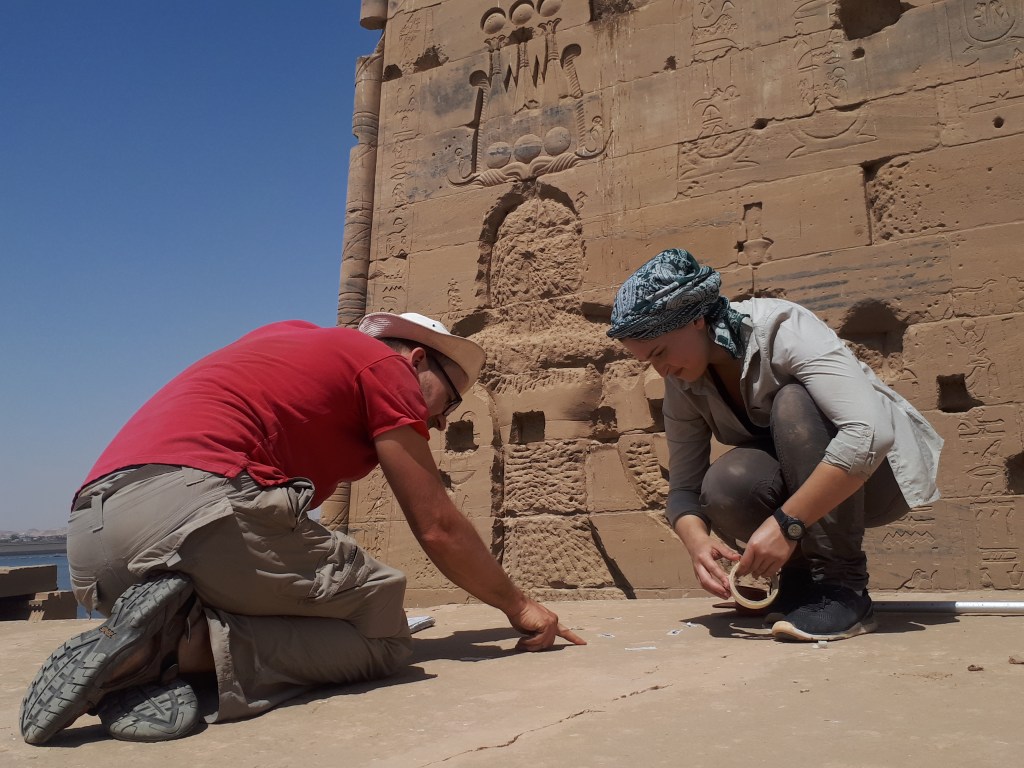 Dr. Jitse Dijkstra and a graduate student working at the Temple of Isis at Philae