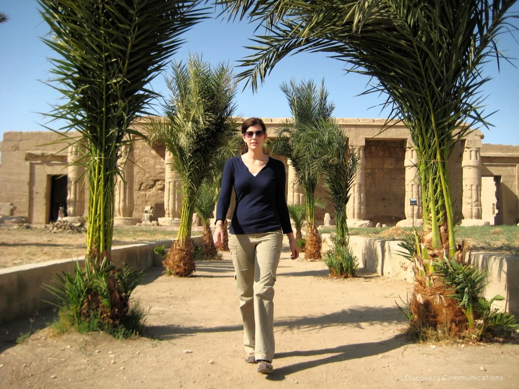 Photo of Dr. Kara Cooney walking in front of an Egyptian temple. 