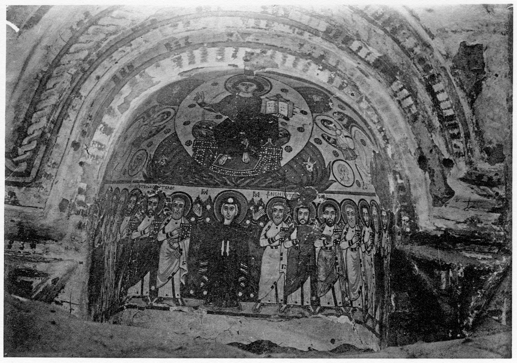 Photo of a painting of Mary in a wall niche from a monastery in Egypt. She is standing in the bottom centre of the composition flanked by several men on either side. Christ is in the upper register in a mandorla. 
