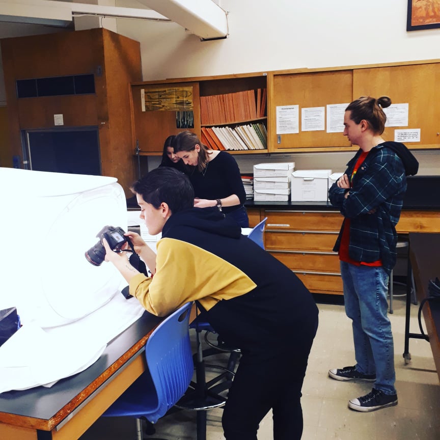 Students photographing their objects using a lightbox.