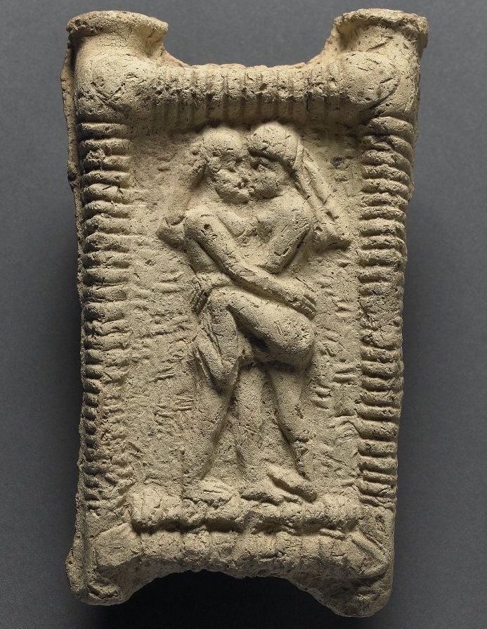 Two lovers are entwined, carved in  terracotta