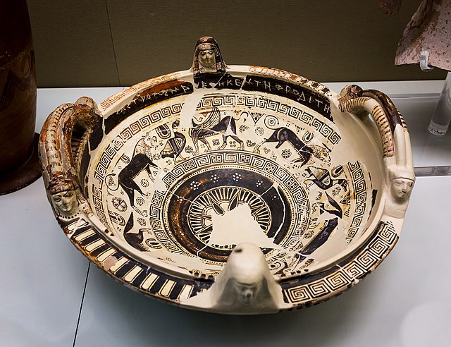 Image of painted bowl with procession of animals around interior along with geometric ornament and Greek dedication
