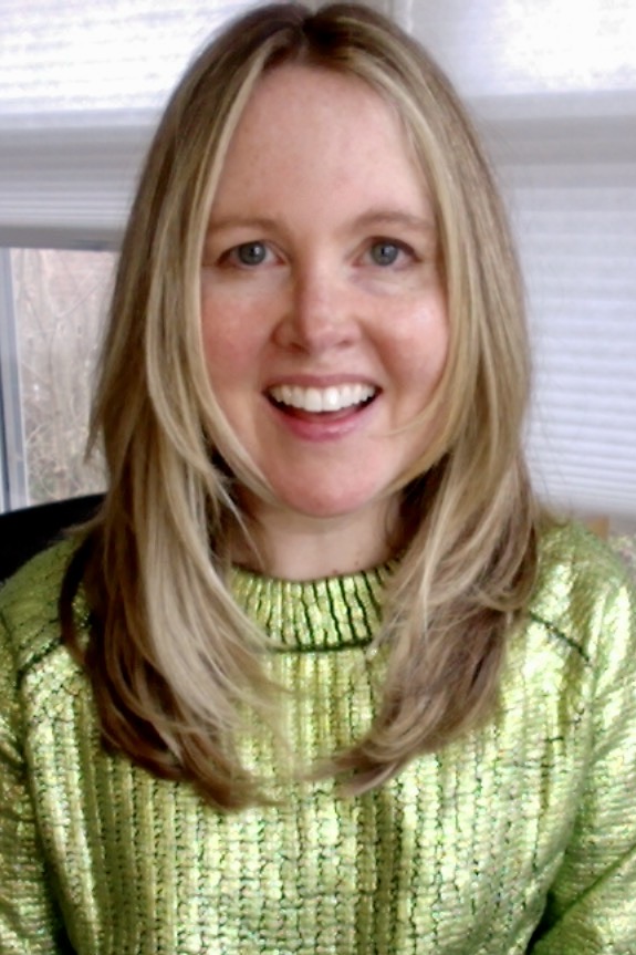 A selfie of Dr. Lauren Caldwell, a white woman with blond hair, wearing a lime green sweater. 