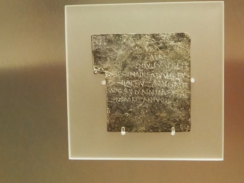 A led curse tablet with a curse inscribed in Latin on it. 