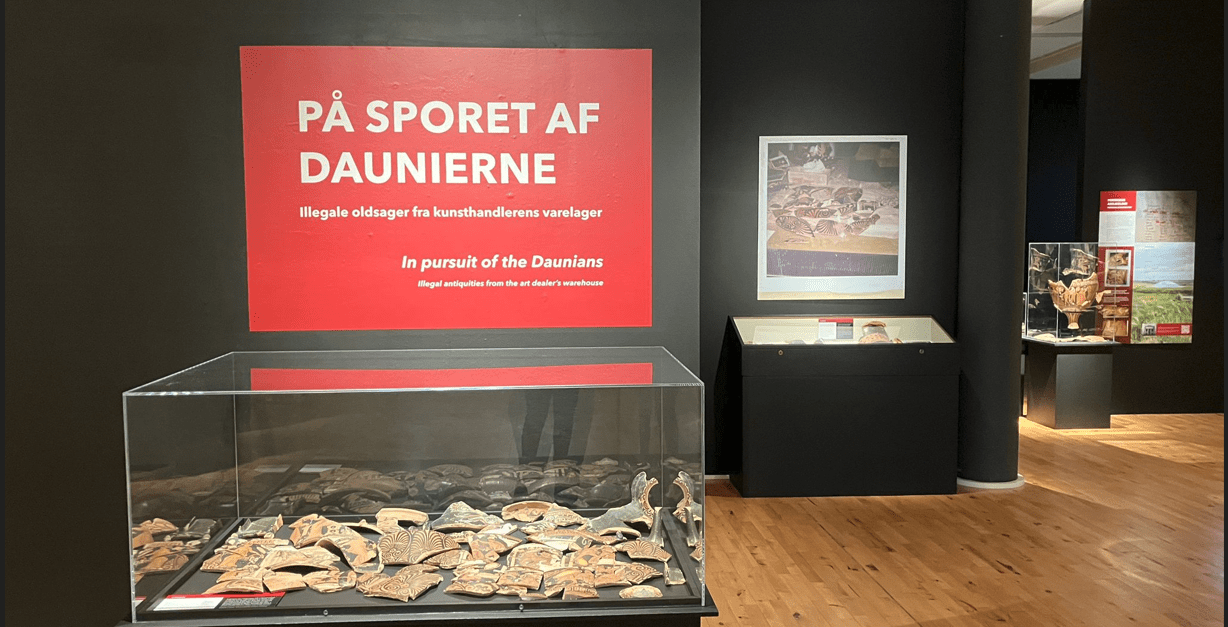 Image of a museum gallery with three different displays of illicitly acquired vases visible