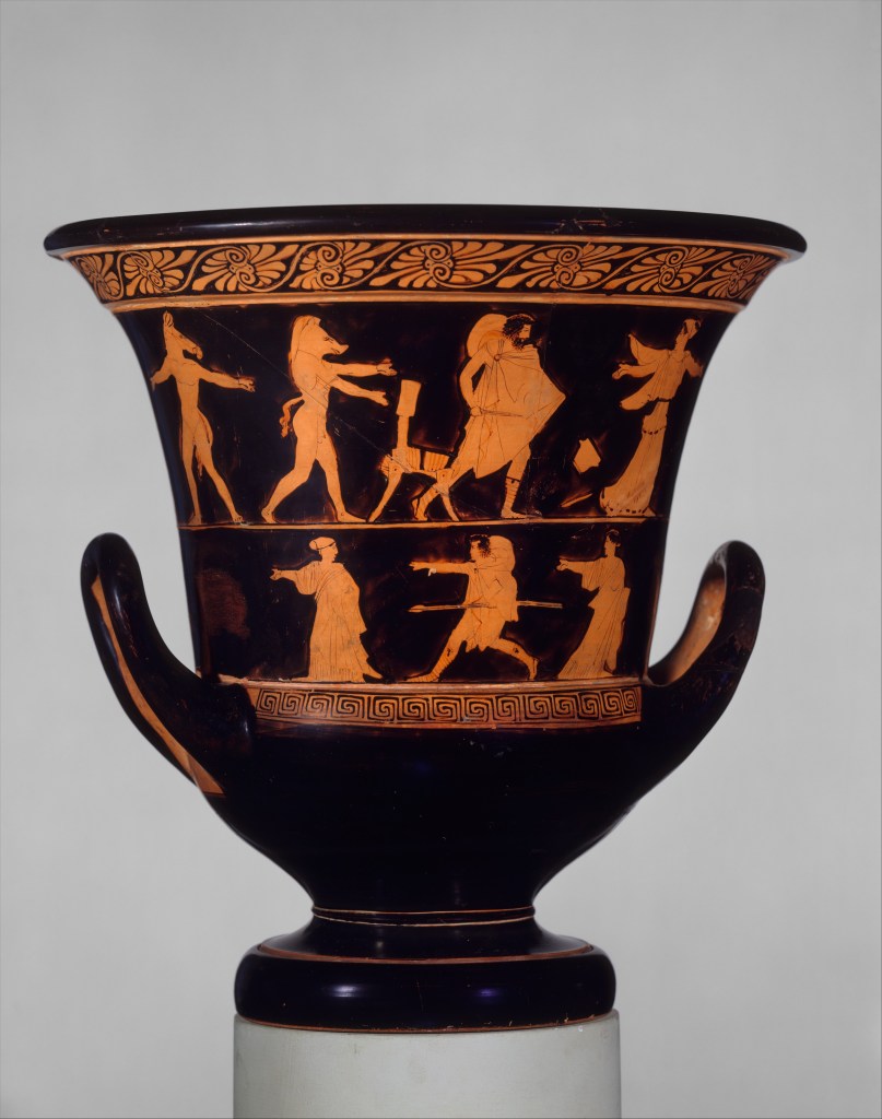 An ancient Greek terracotta vase featuring two registers of red-figure decoration against a painted black background. The vessel has a wide, flared rim decorated with a stylized floral pattern, a deep body with two large loop handles curving upward, and a stout, round foot. The upper register depicts four figures: at right, a woman runs and looks back over her shoulder at a man who pursues her with a sword drawn. Behind the man is a chair and two men with human bodies and animal heads.